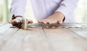 man counting coins on table