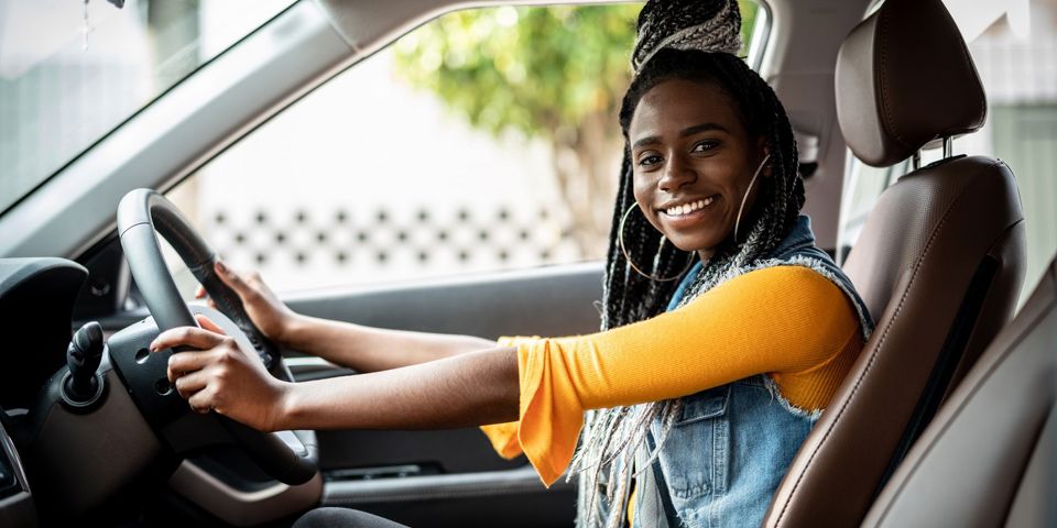 Young woman sitting in car