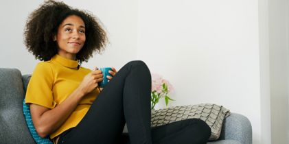 woman with mug on couch