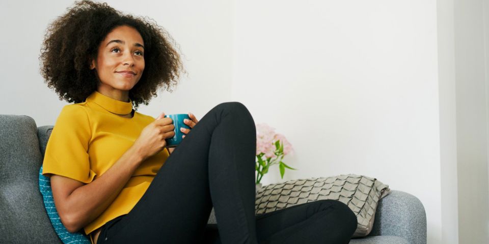 woman with mug on couch