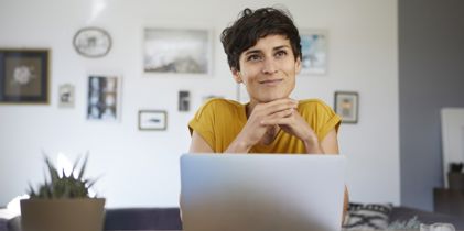 thinking woman in front of laptop