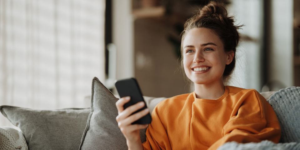  woman on couch with cellphone