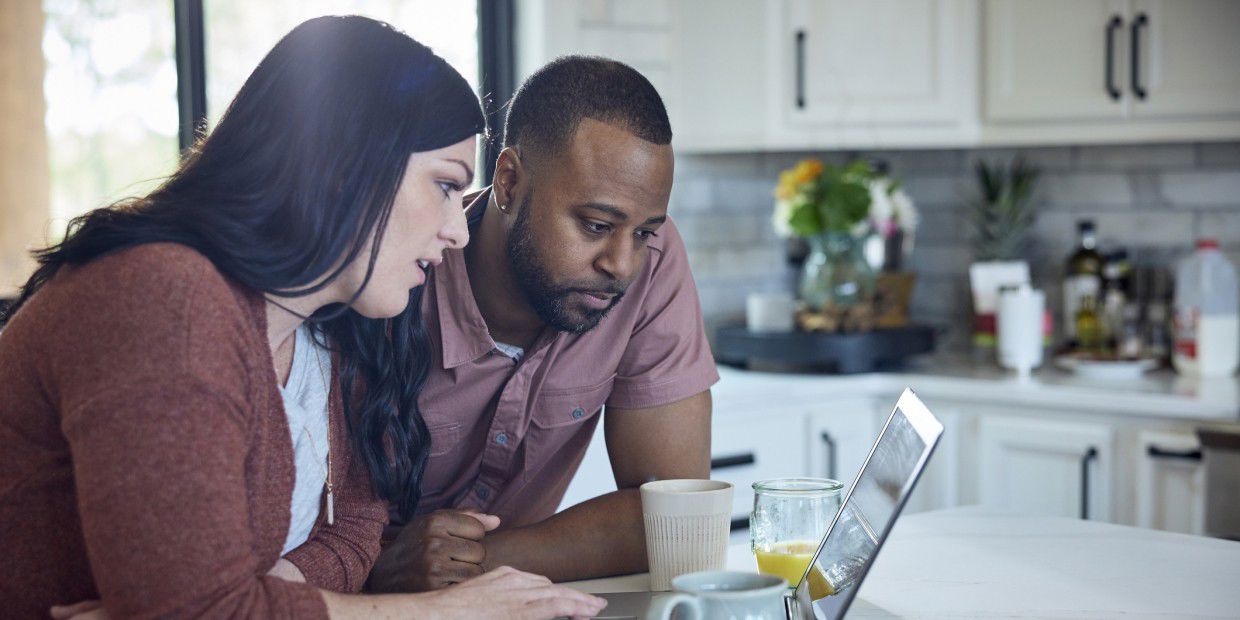 man and women looking at laptop