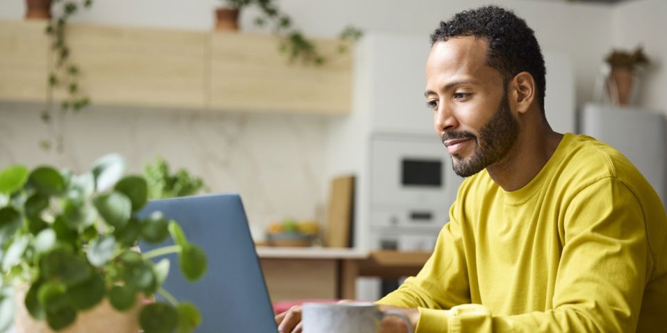 Man looking at laptop and smiling