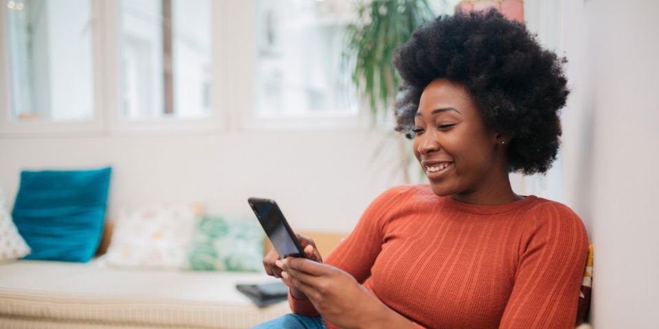 woman smiling at her phone