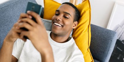 Young man on couch with cellphone
