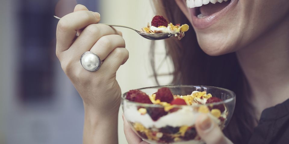 woman eating fruit and yoghurt