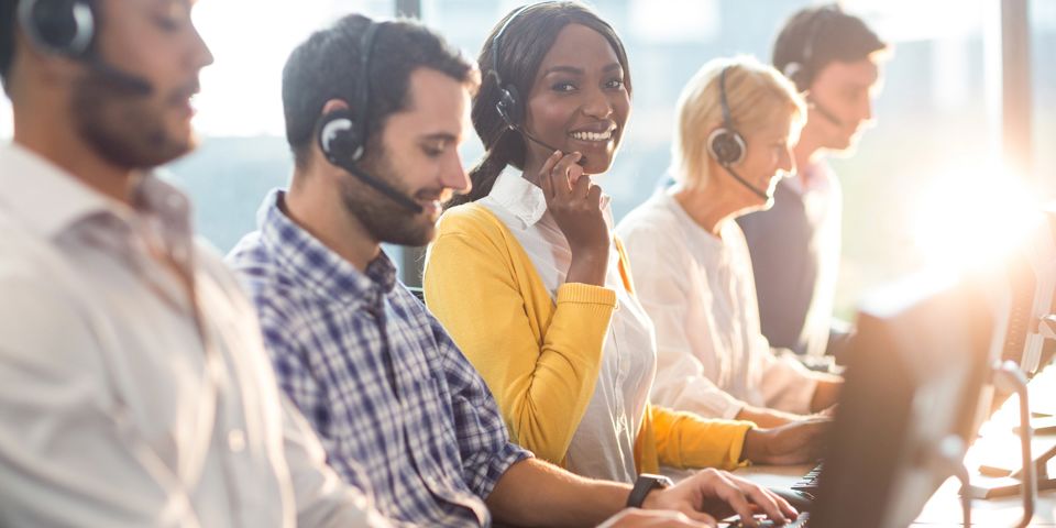 Woman smiling at camera in call centre