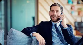 suite man seated using cell phone